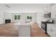 Open concept kitchen with stainless appliances, white countertops, and a fireplace in the living area at 11131 Cardinal Creek Ave, Charlotte, NC 28215