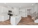 Open kitchen featuring a large island, stainless steel appliances, and white cabinets at 11131 Cardinal Creek Ave, Charlotte, NC 28215