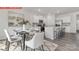 Eat-in kitchen area boasts modern white cabinetry and stainless steel appliances with a dining table at 11131 Cardinal Creek Ave, Charlotte, NC 28215