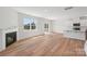 Open-concept living area with a fireplace, wood flooring, and a view of the kitchen at 11131 Cardinal Creek Ave, Charlotte, NC 28215