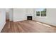 Living room with wood floors, a fireplace, and a bright window bringing in natural light at 11131 Cardinal Creek Ave, Charlotte, NC 28215