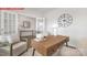 Bright home office with a wooden desk, decor, neutral walls, and large windows allowing for natural light at 11131 Cardinal Creek Ave, Charlotte, NC 28215