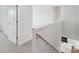 Stairway with carpet, white walls, and wooden handrail leading to an open kitchen area at 11131 Cardinal Creek Ave, Charlotte, NC 28215