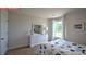 Comfortable bedroom featuring a floral bedspread, a large window, and a modern white dresser at 11213 Cardinal Creek Ave, Charlotte, NC 28215