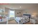 Charming bedroom with a floral bedspread, large window, and matching nightstands and dresser at 11213 Cardinal Creek Ave, Charlotte, NC 28215