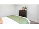 A well lit bedroom with a dresser, and view of two interior doors at 11213 Cardinal Creek Ave, Charlotte, NC 28215