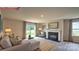 Bright living room with fireplace, large windows, and sliding glass doors to the outdoor living space at 11213 Cardinal Creek Ave, Charlotte, NC 28215