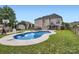 Large backyard featuring a swimming pool, lush green grass, and an entertainment space at 113 Dairy Farm Rd, Mooresville, NC 28115