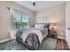 Cozy bedroom with a ceiling fan, large window, and neutral decor at 113 Dairy Farm Rd, Mooresville, NC 28115
