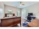 Comfortable bedroom with a ceiling fan, natural light, and a dedicated workspace at 113 Dairy Farm Rd, Mooresville, NC 28115