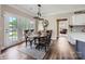 Cozy dining area with hardwood floors, stylish light fixture, and easy access to outdoor patio at 113 Dairy Farm Rd, Mooresville, NC 28115