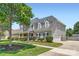 Charming two-story home featuring well-maintained landscaping, a two-car garage and a welcoming entryway at 113 Dairy Farm Rd, Mooresville, NC 28115