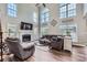 Bright living room with a fireplace, large windows, hardwood floors, and plush seating at 113 Dairy Farm Rd, Mooresville, NC 28115