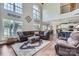 Open-concept living room with soaring ceilings, large windows, and a seamless flow to the kitchen and dining area at 113 Dairy Farm Rd, Mooresville, NC 28115