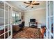 A well-lit office space with a ceiling fan, large windows, and a cozy daybed at 113 Dairy Farm Rd, Mooresville, NC 28115
