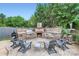 Cozy outdoor space with a built-in stone fireplace, grill, and comfortable seating at 113 Dairy Farm Rd, Mooresville, NC 28115