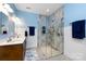 Bright bathroom featuring a glass-enclosed shower, double vanity, and modern fixtures at 139 Harper Lee St, Davidson, NC 28036