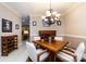 Elegant dining room featuring modern chandelier, wood table with seating for four, and a wine rack at 139 Harper Lee St, Davidson, NC 28036