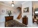 Elegant foyer with staircase, neutral walls, decorative rug, and wood accents exudes warmth at 139 Harper Lee St, Davidson, NC 28036