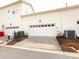 Attached two-car garage with driveway and exterior AC units at 139 Harper Lee St, Davidson, NC 28036