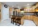 Bright kitchen with granite countertops, tile backsplash, stainless steel appliances, and kitchen island at 139 Harper Lee St, Davidson, NC 28036