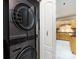 Modern laundry area featuring a stacked washer and dryer, located near the kitchen at 139 Harper Lee St, Davidson, NC 28036