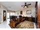 Comfortable living room with ceiling fan, built-in cabinet, leather chairs, and great natural lighting at 139 Harper Lee St, Davidson, NC 28036