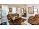 Cozy living room showcasing tile floors, shutters, comfortable seating, and bright natural light at 139 Harper Lee St, Davidson, NC 28036