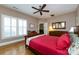 Comfortable main bedroom with hardwood floors, ample natural light, ceiling fan, and a cozy bed at 139 Harper Lee St, Davidson, NC 28036