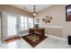 Bright office space with light-filled windows, a wooden desk, and a cozy rug, perfect for a productive workspace at 139 Harper Lee St, Davidson, NC 28036