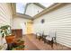Private brick patio with outdoor seating, potted plants, and a yellow door at 139 Harper Lee St, Davidson, NC 28036