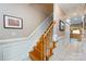 Classic staircase with wood steps, white risers, and elegant wainscoting leading upstairs at 139 Harper Lee St, Davidson, NC 28036