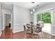 Dining area featuring hardwood floors and a sliding glass door leading to the backyard at 13930 Wild Heather Ct, Charlotte, NC 28273