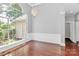 Elegant dining room with hardwood floors, wainscoting, and large arched window at 13930 Wild Heather Ct, Charlotte, NC 28273