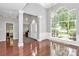 Open-concept dining area features hardwood floors, chandelier, and oversized window at 13930 Wild Heather Ct, Charlotte, NC 28273
