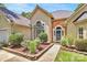 Inviting front entrance with stone accents, beautiful garden beds, and a lovely front door at 13930 Wild Heather Ct, Charlotte, NC 28273