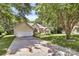 Welcoming front exterior with an attached garage and a long driveway, set amongst mature trees at 13930 Wild Heather Ct, Charlotte, NC 28273