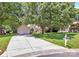 Beautiful front exterior with a long driveway and well-maintained landscaping, under the shade of mature trees at 13930 Wild Heather Ct, Charlotte, NC 28273