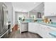 Kitchen with stainless steel appliances, white cabinets, and modern tile flooring at 13930 Wild Heather Ct, Charlotte, NC 28273