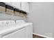 Well-lit laundry room equipped with modern appliances and ample storage space at 13930 Wild Heather Ct, Charlotte, NC 28273