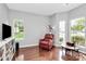 Bright living room filled with natural light, hardwood floors, and a cozy red armchair at 13930 Wild Heather Ct, Charlotte, NC 28273
