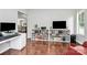 Home office area features hardwood floors, white bookshelf, and white desk at 13930 Wild Heather Ct, Charlotte, NC 28273
