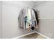 Walk-in closet with white wire shelving for storage of personal items and clothing at 13930 Wild Heather Ct, Charlotte, NC 28273