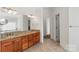 Bright bathroom features double vanity, granite counters, tile floor and soaking tub at 15216 Ballantyne Country Club Dr, Charlotte, NC 28277