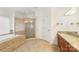 Primary bathroom featuring tiled floors, a jacuzzi tub, a glass enclosed shower, and wood cabinets with granite counters at 15216 Ballantyne Country Club Dr, Charlotte, NC 28277