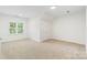 Spacious bedroom with natural light from the window, and neutral carpet at 15216 Ballantyne Country Club Dr, Charlotte, NC 28277