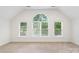Bright bedroom with large windows offering abundant natural light and backyard views at 15216 Ballantyne Country Club Dr, Charlotte, NC 28277