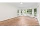 A bright bonus room with neutral carpeting, white trim, and windows overlooking the backyard pool at 15216 Ballantyne Country Club Dr, Charlotte, NC 28277