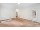 A bonus room featuring neutral carpeting, white trim, and a door leading to the exterior at 15216 Ballantyne Country Club Dr, Charlotte, NC 28277