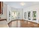 Bright dining area features hardwood floors, a chandelier, a large bay window and sliding glass doors at 15216 Ballantyne Country Club Dr, Charlotte, NC 28277